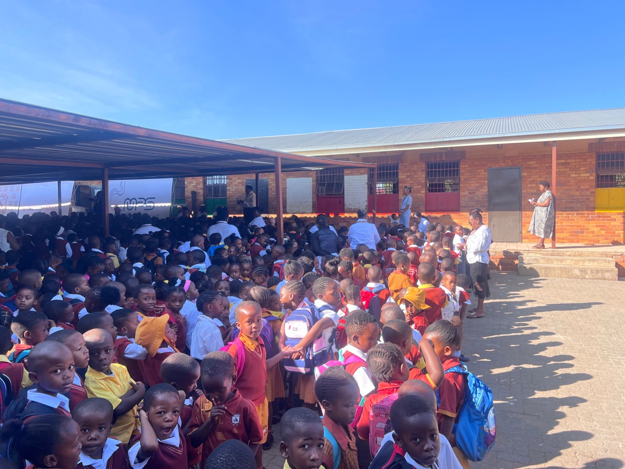 Hundreds of Sithokomela Primary School learners in maroon and yellow uniforms gathered in the school courtyard