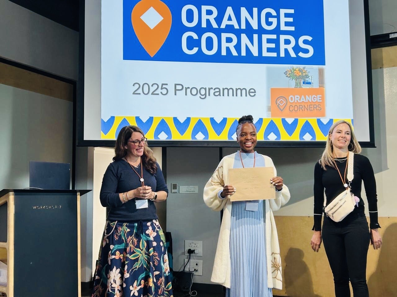 Nthabiseng receives her award on stage at the Orange Corners 2025 programme